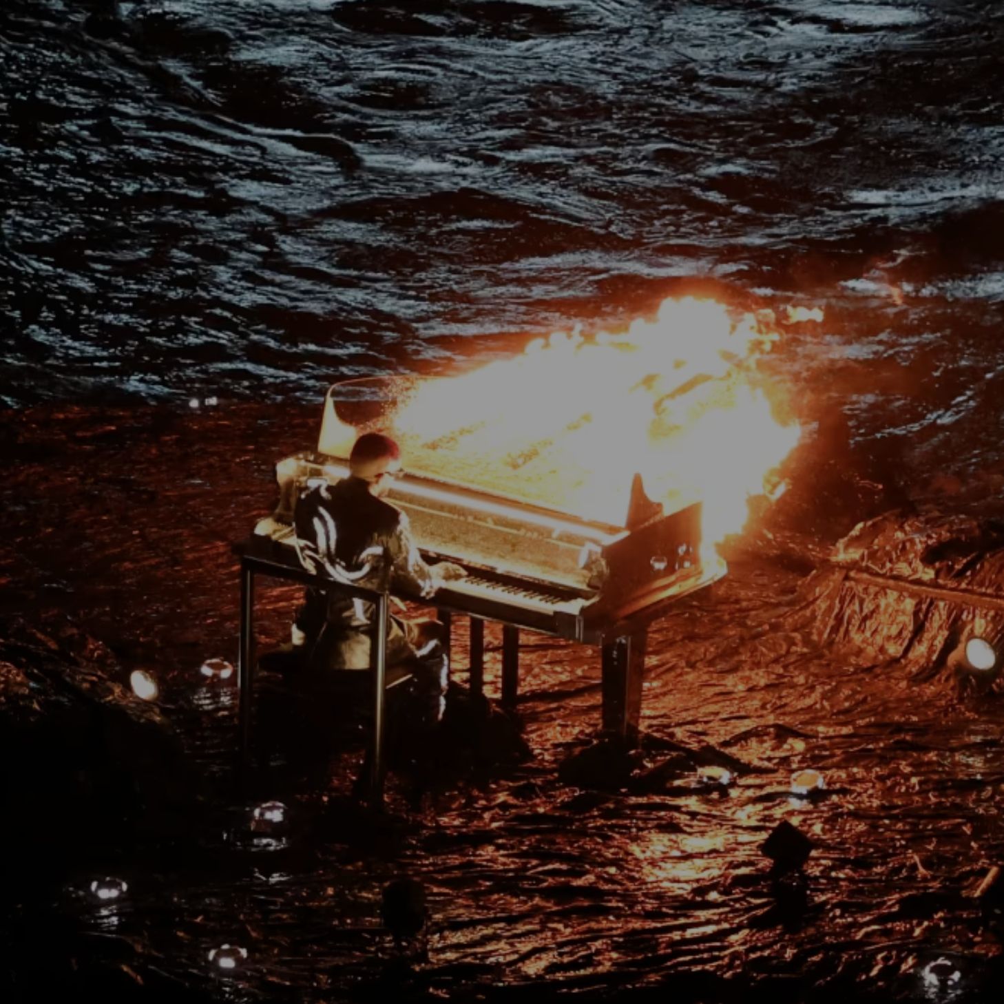 A burning piano on stage at a One Last Prompt gathering
